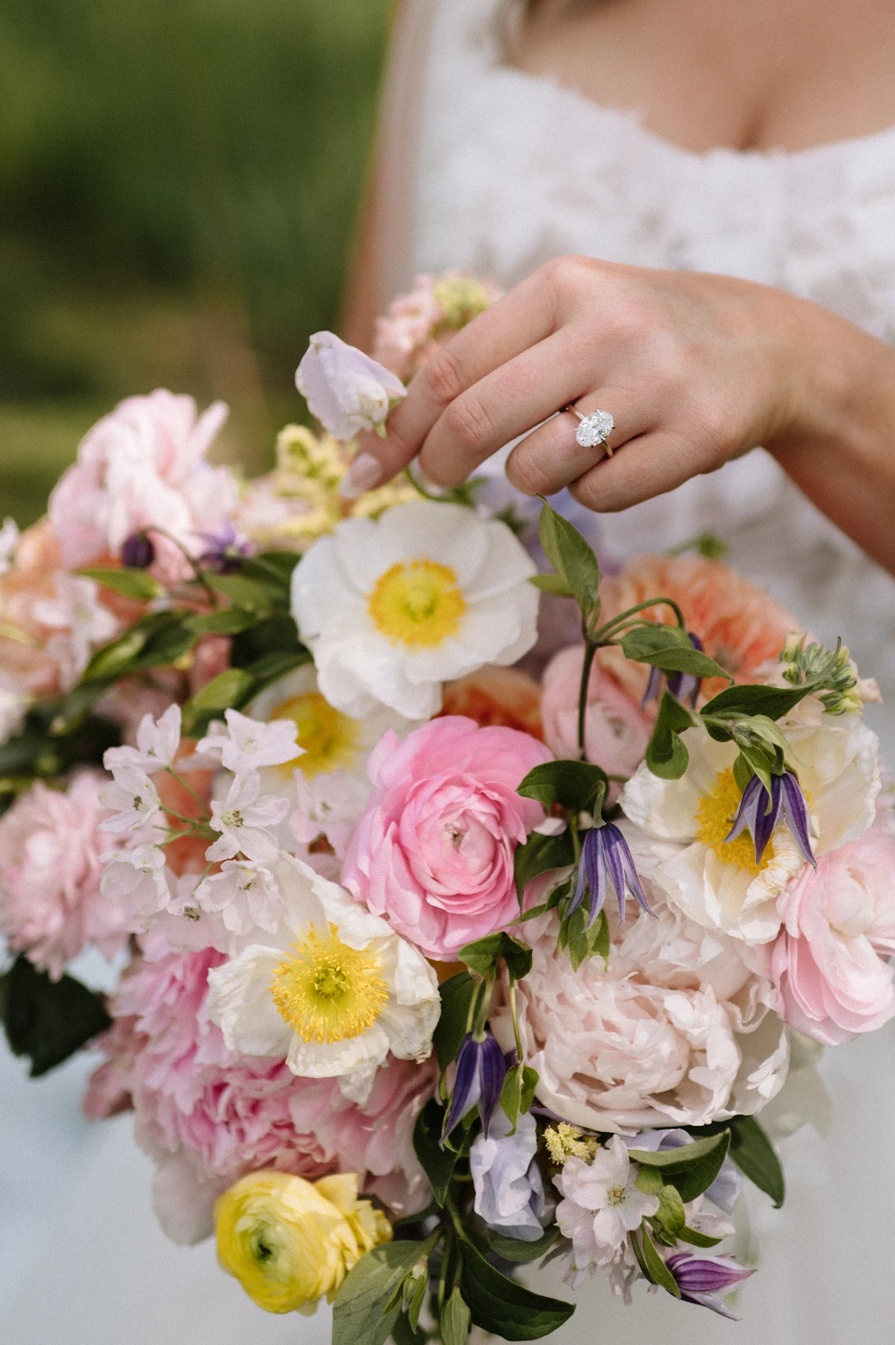 Bouquet of flowers held by a person with a blurred background