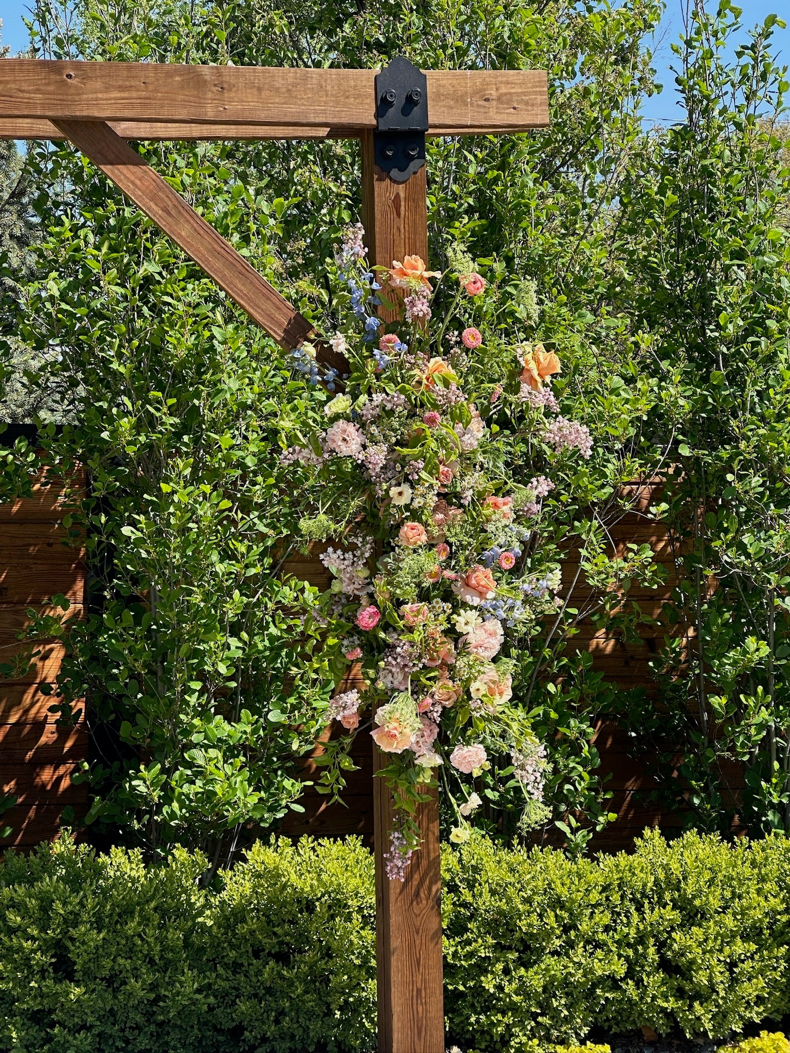 Floral archway with flowers against a green foliage background