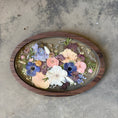 Load image into Gallery viewer, Decorative piece with pressed flowers in a wooden frame on a concrete surface
