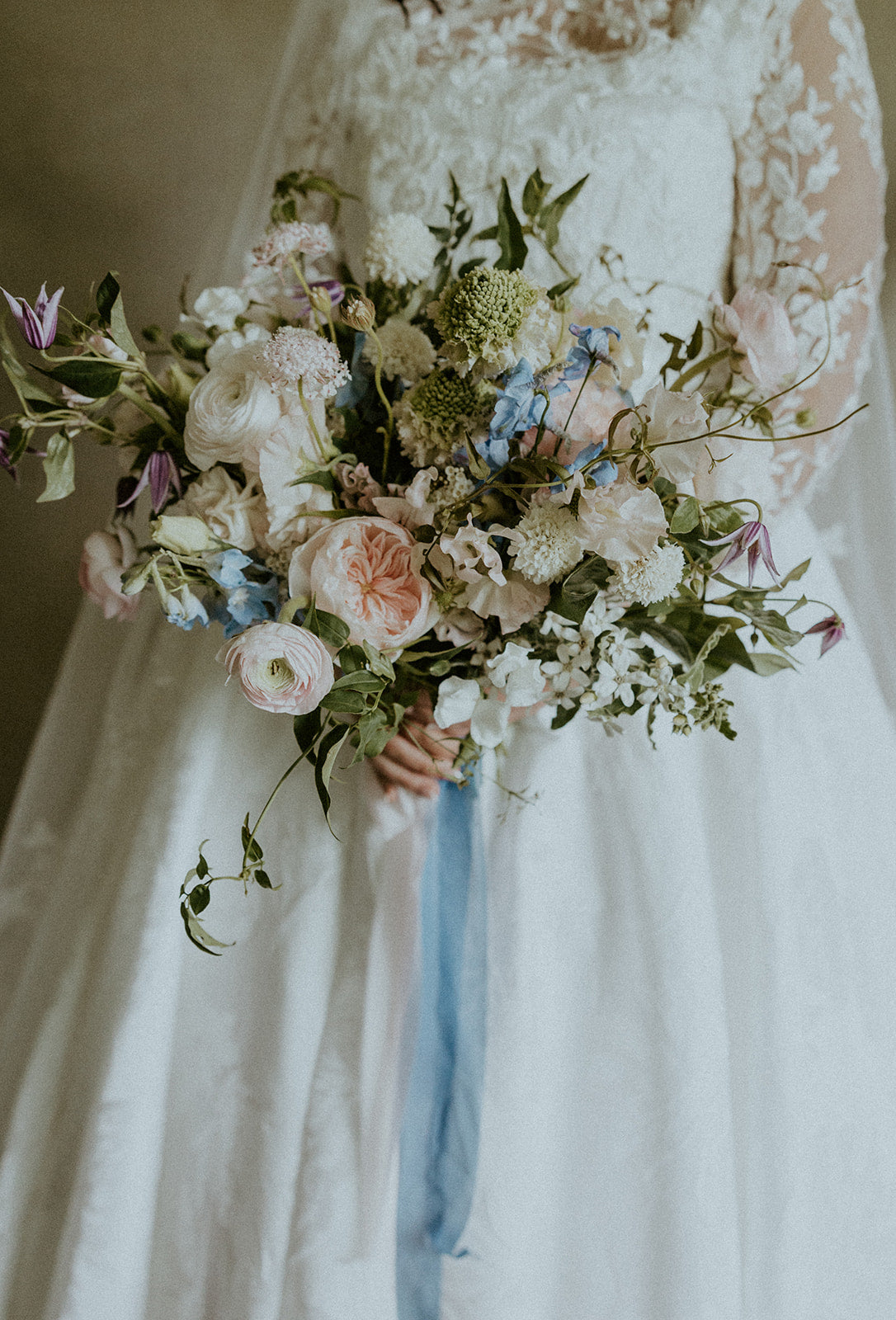 Bride holding a bouquet of flowers with a blurred background
