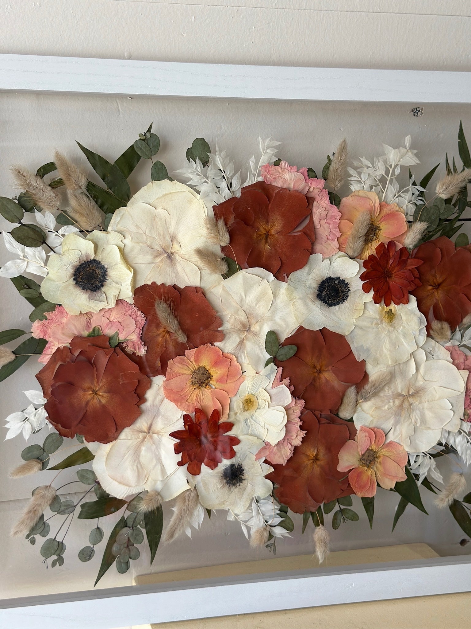 Bouquet of flowers with red, white, and pink colors in a white frame