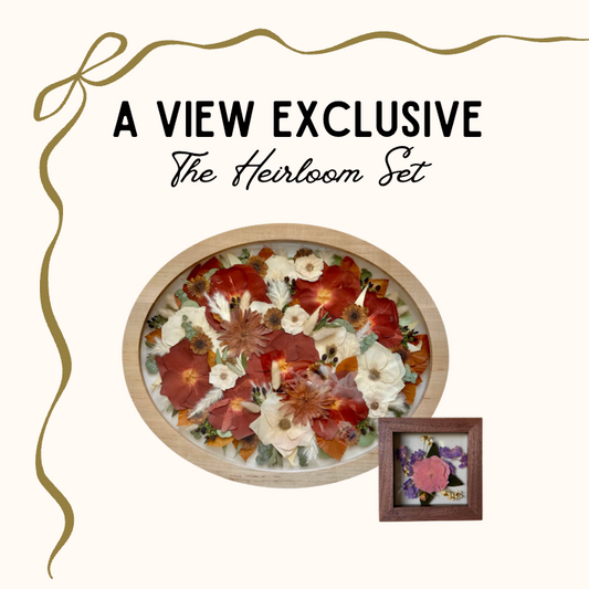 Decorative set with floral arrangement and framed item on a white background, labeled 'A View Exclusive The Heirloom Set'.